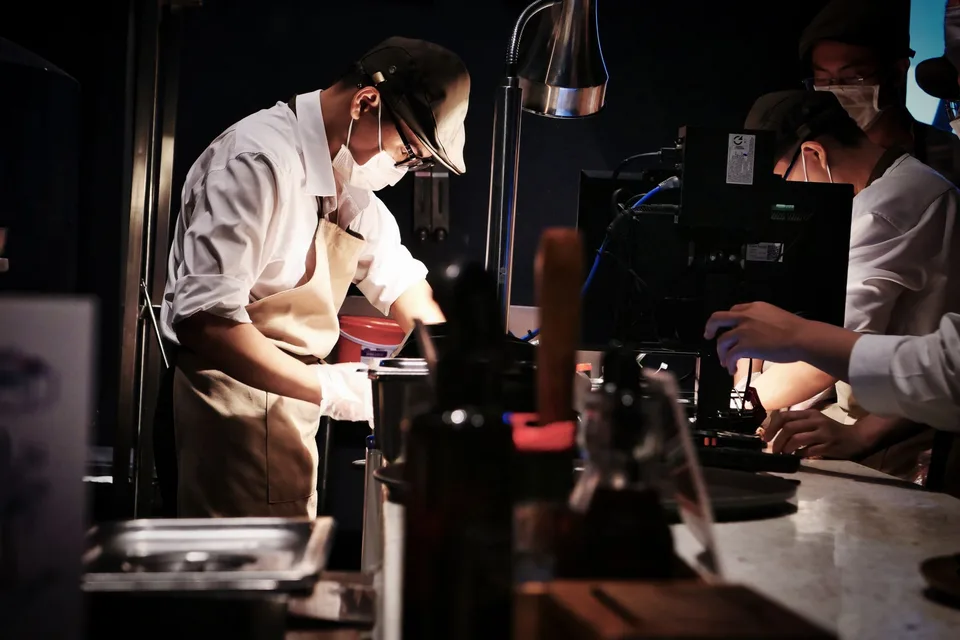 Chefs preparing dishes together in a professional kitchen